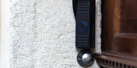 Sonnette moderne sur mur texturé, prête pour la réparation. Que ce soit pour un locataire ou un propriétaire, une sonnette fonctionnelle est essentielle.
