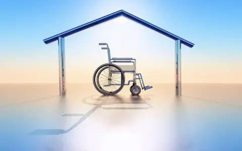 Fauteuil roulant sous un toit stylisé, symbolisant le logement PMR en location.